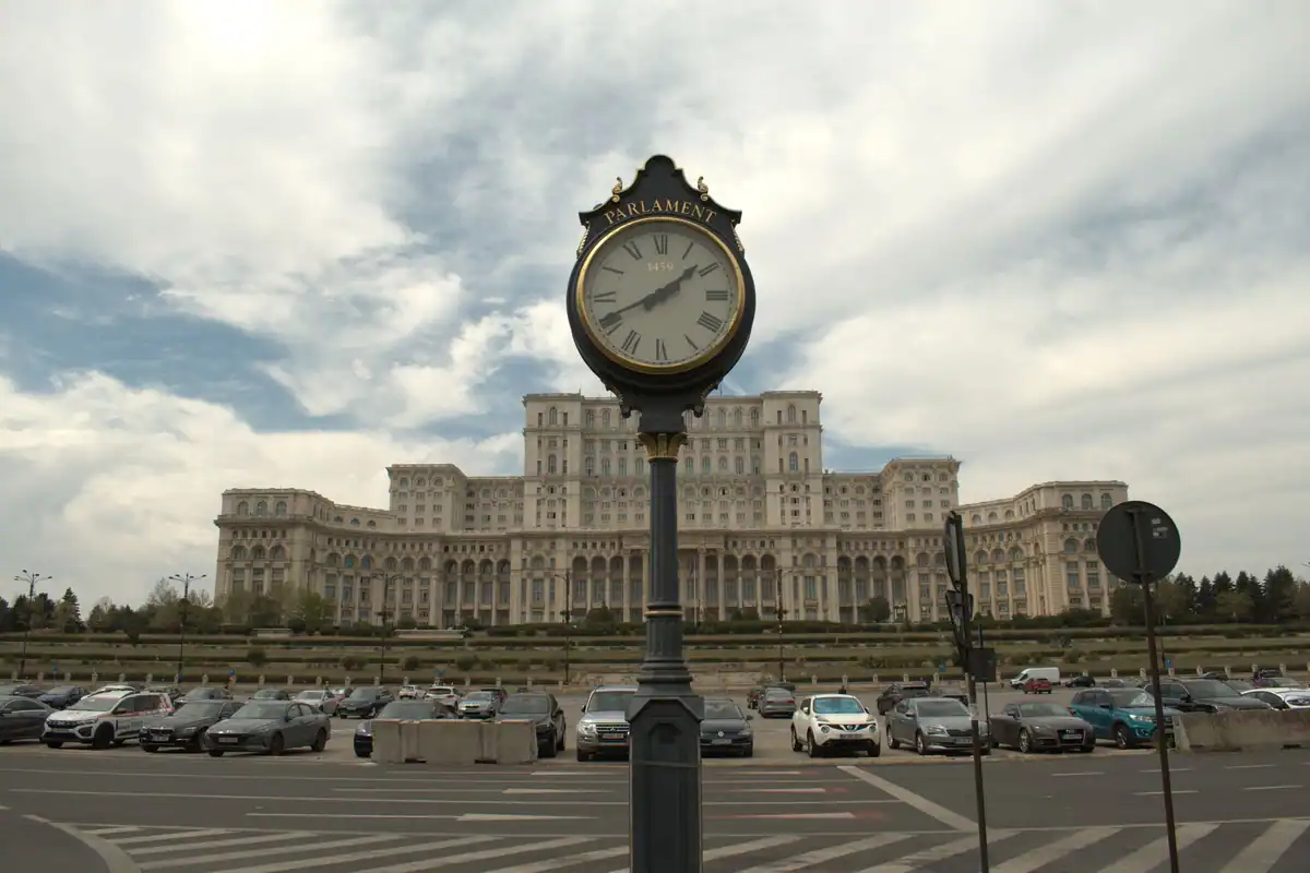 Palatul Parlamentului din București, cu ceasul de pe trotuar în față